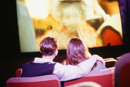 Couple watching a film at the cinema