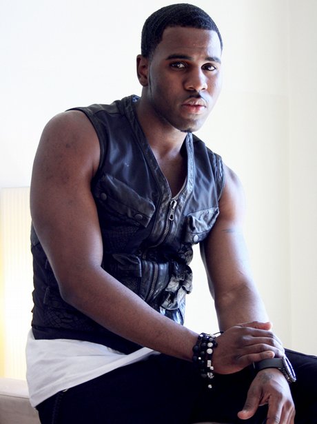 Jason Derulo posing in black sleeveless top