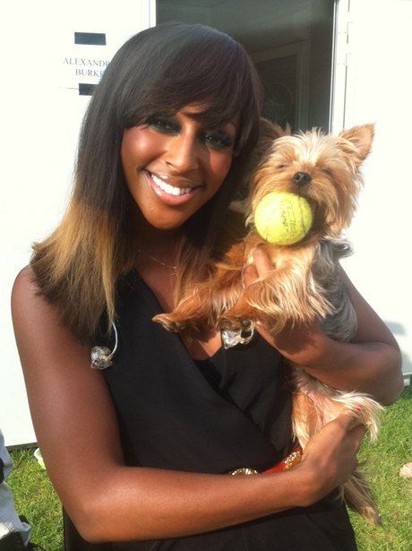 Alexandra Burke holding her dog