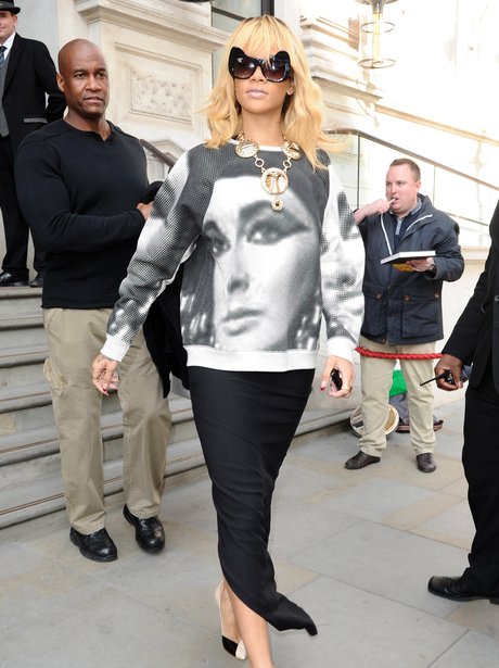 Rihanna in London wearing an jumepr with Elizabeth Taylors face on.