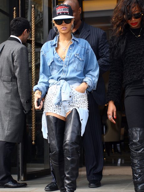 Rihanna in London weariing studded denim shorts and knee high leather boots