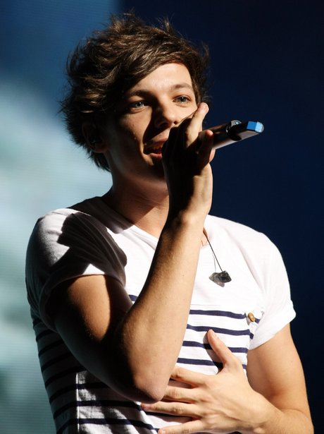 One Direction's Louis Tomlinson performing on stage.
