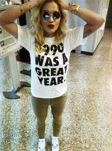 Rita Ora poses in a black and white t-shirt