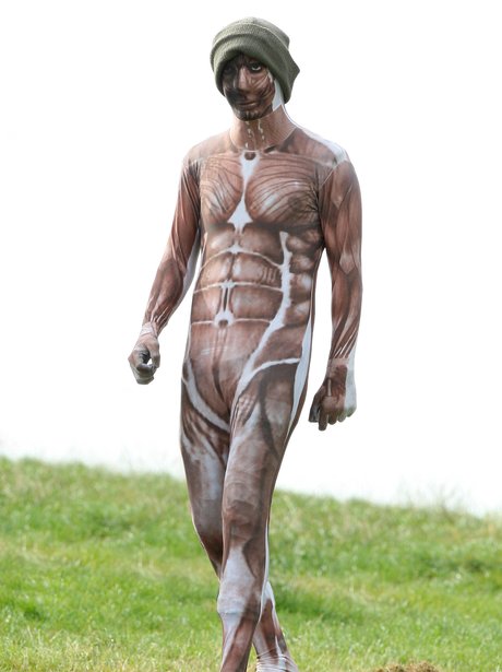 Harry Styles wearing a muscle morphsuit.