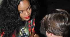 Rihanna signs an autograph for young boy