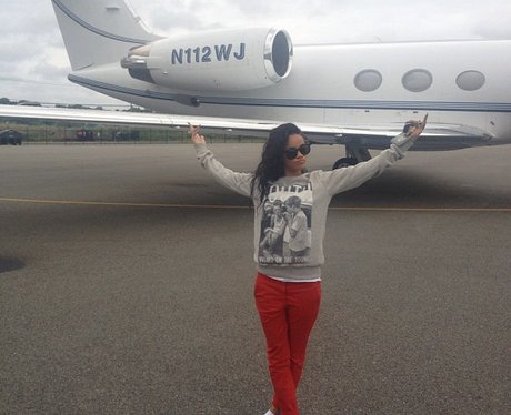 Rihanna next to a private jet.