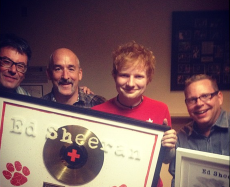 Ed Sheeran with a gold disc