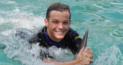 Louis Tomlinson swims with dolphins