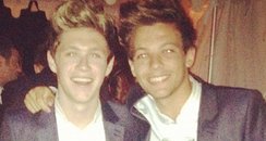 Niall Horan and Louis Tomlinson wearing the same su