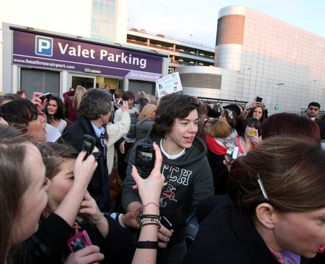 One Direction with fans at the airport.