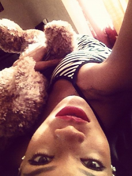 Rihanna cuddling a teddy bear