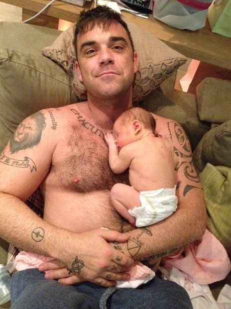 Robbie Williams holding his daughter Teddy