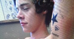 Harry Styles shows of new tattoos