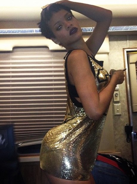 Rihanna wearing a gold dress