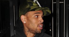 Chris Brown pictured leaving Rihanna's hotel