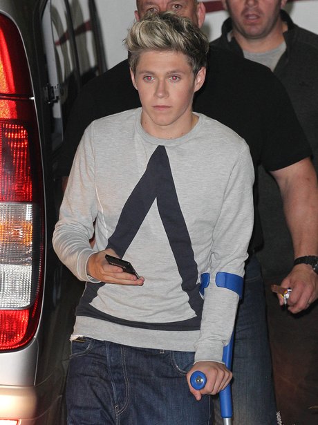 Niall Horan from One Direction on crutches.