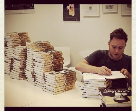 Olly Murs signing autobiographies.