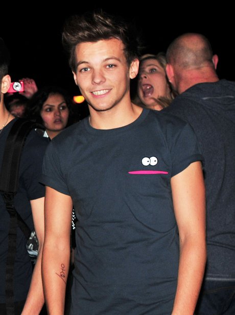 Louis Tomlinson shows off a new tattoo.