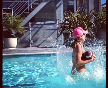 Mollie King playing American football in the pool