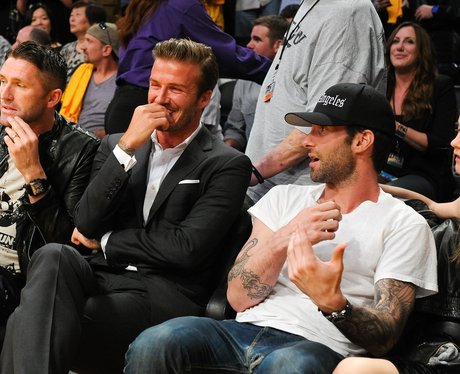 Adam Levine and David Beckham at a basketball game.