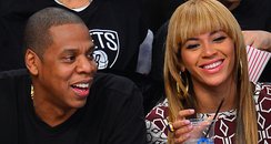 Jay-Z and Beyonce Knowle watch basketball