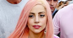 Lady Gaga visits slums in Rio and is mobbed by fan