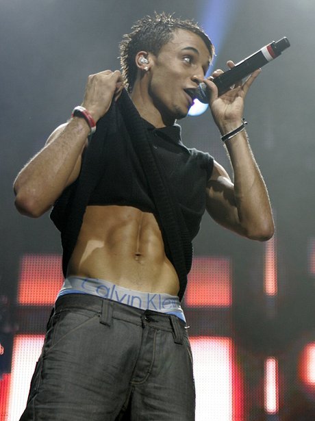 Aston Merrygold revealing his abs on stage