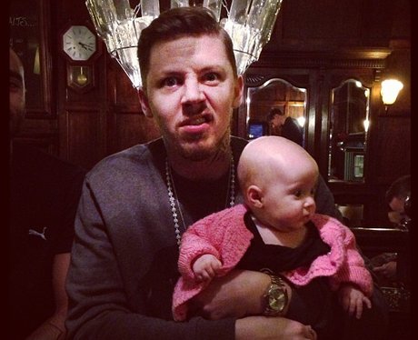 Professor Green holding a baby