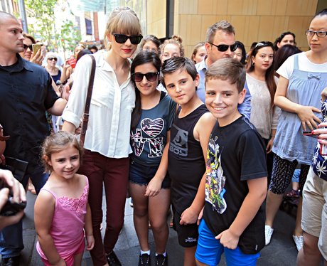 Taylor Swift posing with fans in Australia