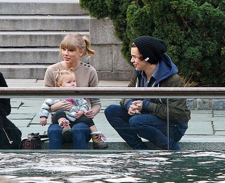 Taylor Swift holding a baby with Harry Styles