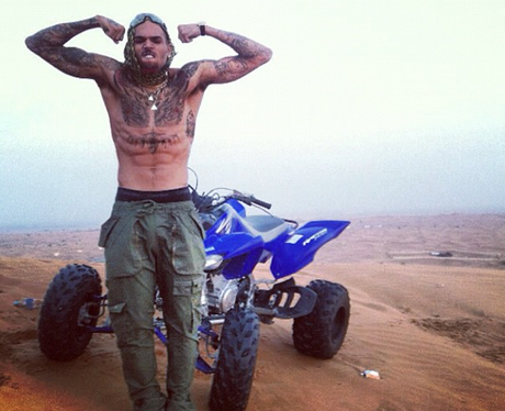 Chris Brown flexing his muscles