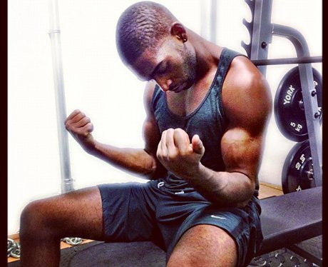 Tinie Tempah flexing his muscles in the gym