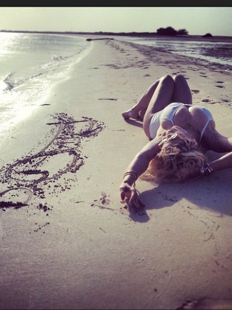 Rita Ora relaxes on a beach