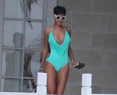 Rihanna wearing a turquoise swimsuit on holiday