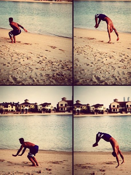 Aston Merrygold doing a back flip on the beach