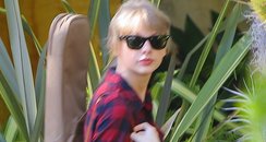 Taylro Swift heads to the studio with her guitar