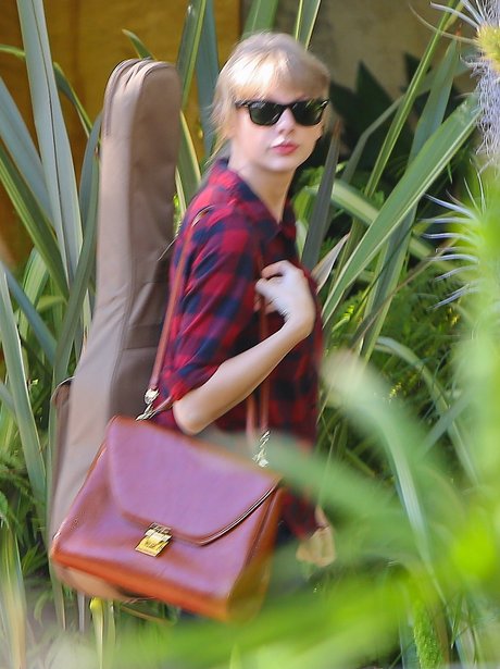 Taylor Swift heads to the studio with her guitar