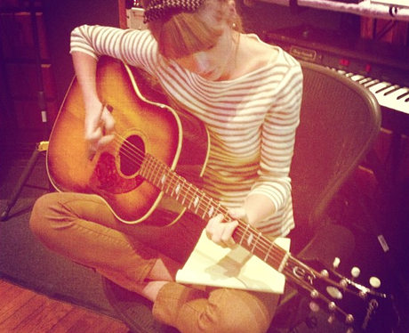 Taylor Swift in the studio with her guitar