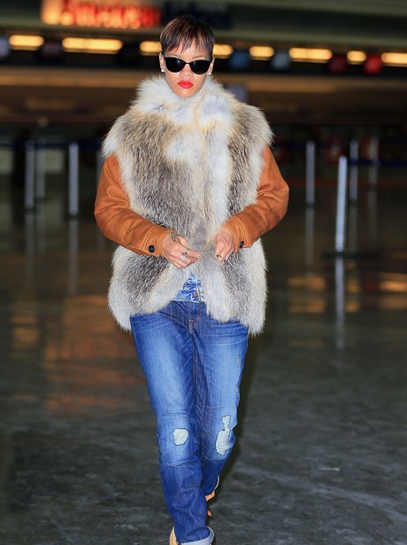Rihanna weatring a fur gillet at New York's JFK airport