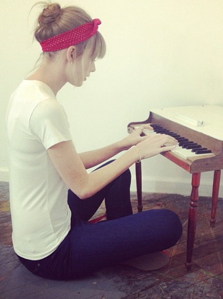 Taylor Swift playing a small piano