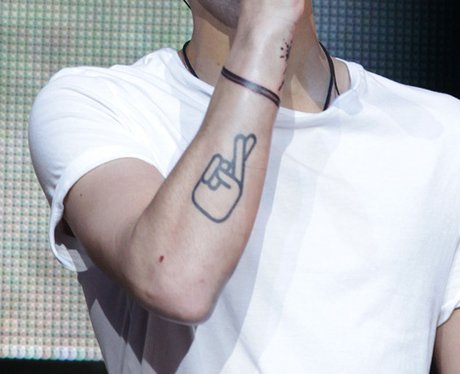 Zayn's simply design of a hand with the fingers crossed has an obvious ...