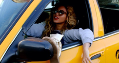 Beyonce in a yellow taxi