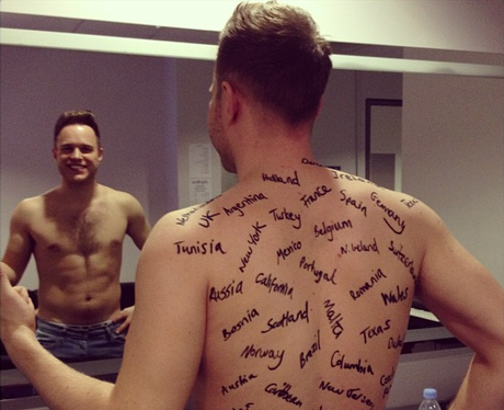 Olly Murs gets lots of country names written on his back