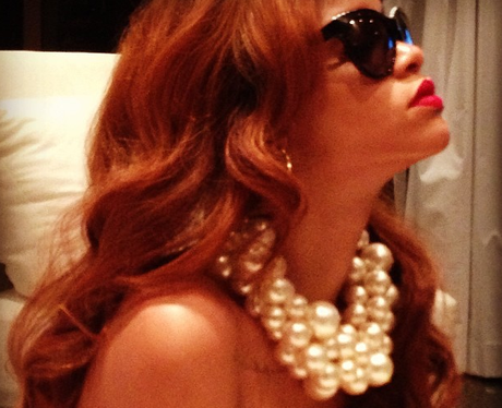 Rihanna wearing sunglasses and pearls