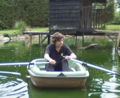 Harry Styles rowing a boat