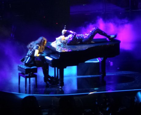 Beyonce lying on a piano
