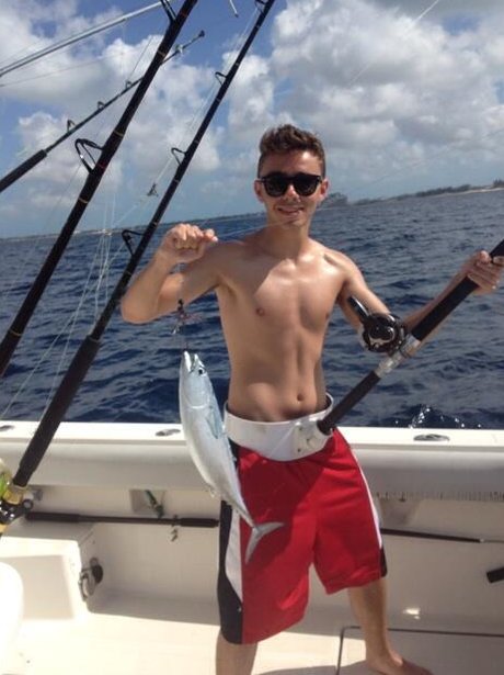 Nathan Sykes shows off his fishing catch