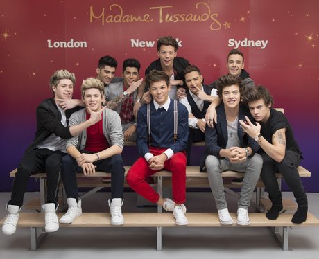 One Direction posing with waxworks at Madame Tussauds