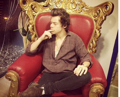 Harry Styles sitting on a throne