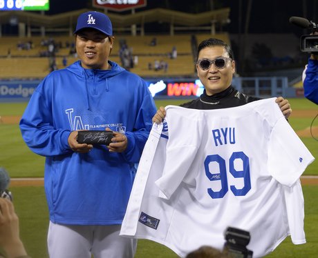 PSY holding a baseball shirt